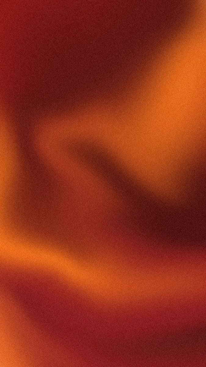 An abstract warm gradient of deep red and orange, like soft folds of fabric or skin in low light.