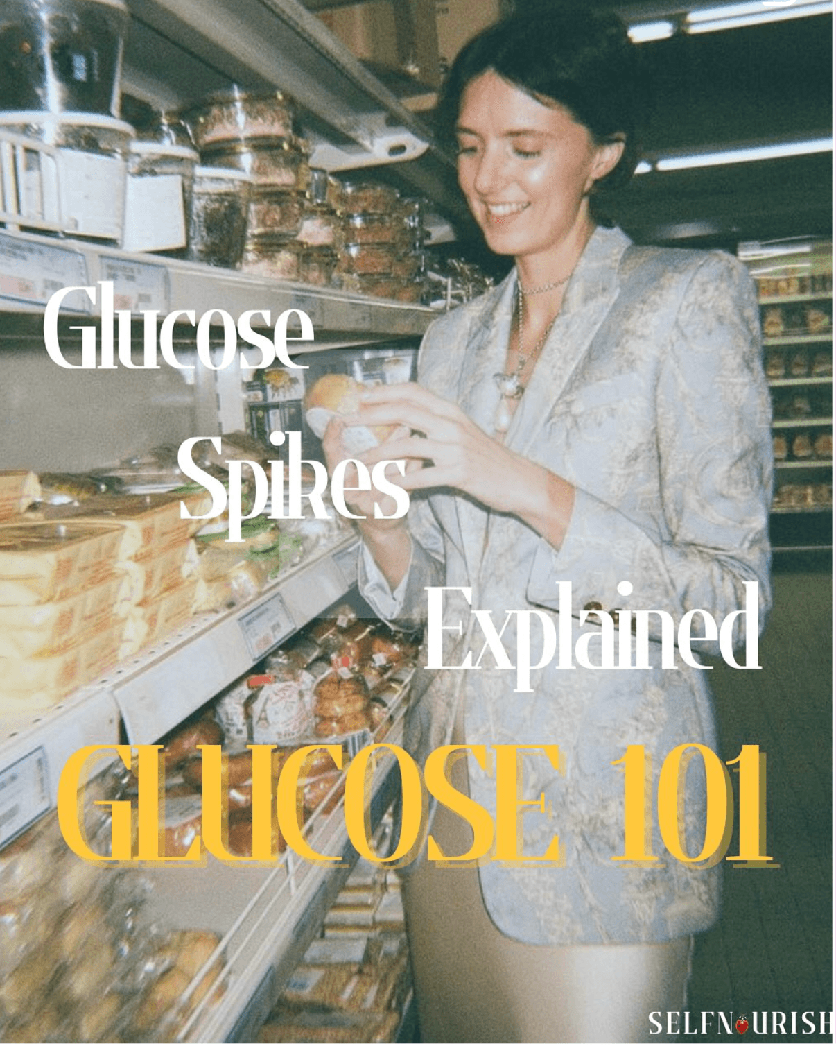 A woman in a tailored suit smiling as she examines a bread roll in a grocery aisle